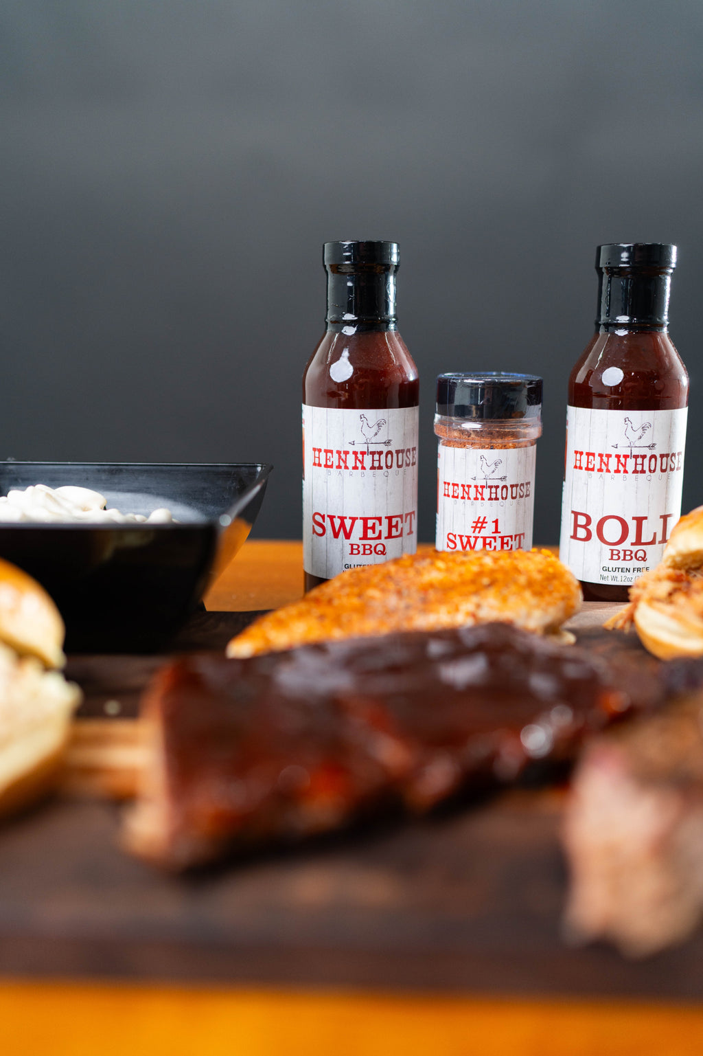 Henn House BBQ sauces and rub close-up with ribs