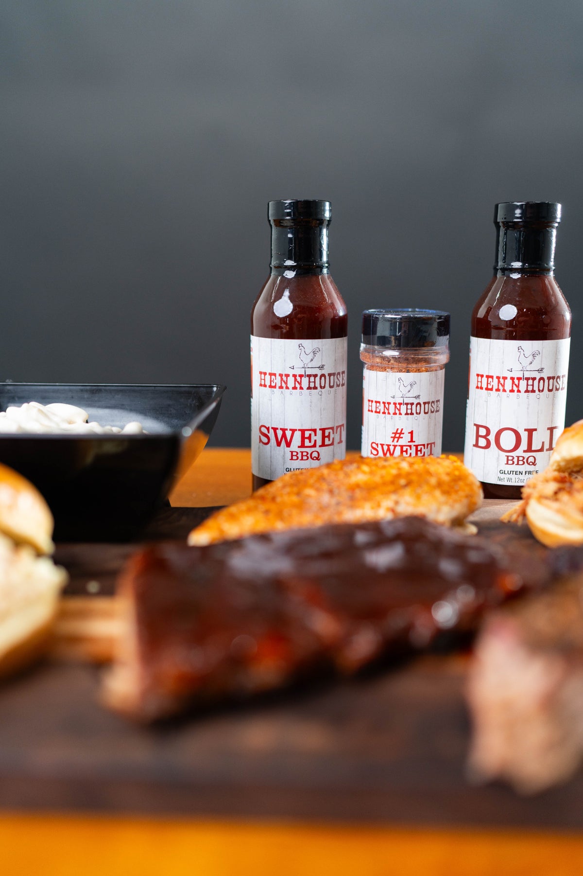 Henn House BBQ sauces and rub close-up with ribs